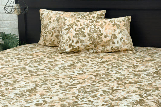 A bed sheet and pillowcases with a floral print in shades of brown displayed on a bed.