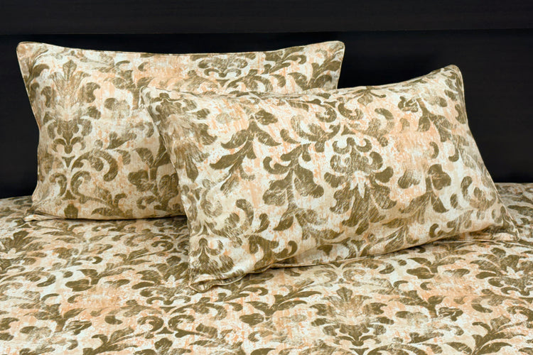 A bed sheet and pillowcases with a floral print in shades of brown displayed on a bed 1.