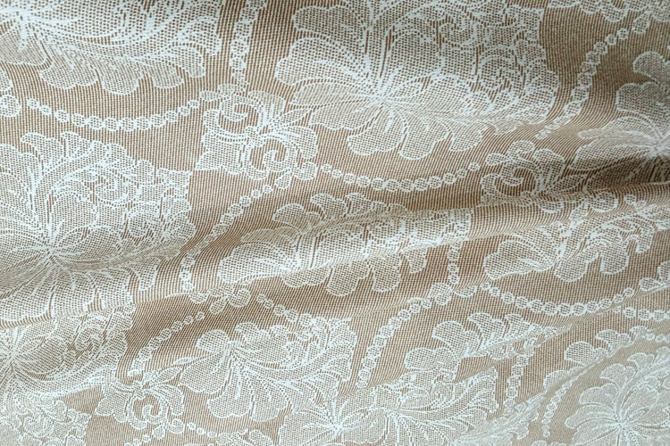 A beige custom bed sheet floral print and piping pattern