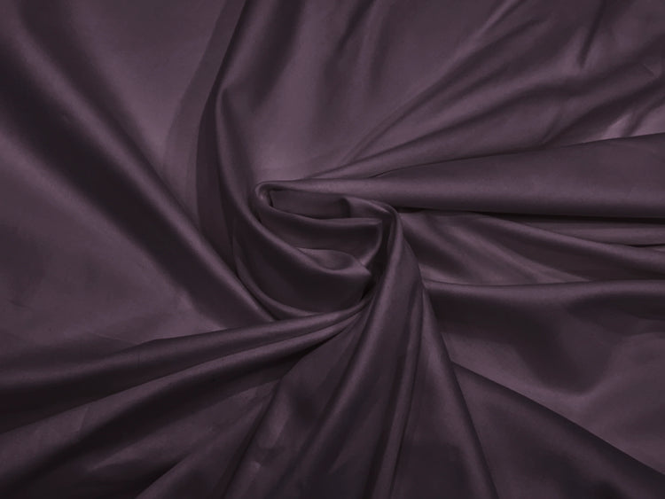 A close-up image of a purple, soft sateen weave bed sheet fabric.