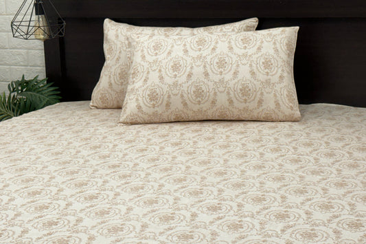 A custom bed sheet set with floral print in shades of beige displayed on a bed.