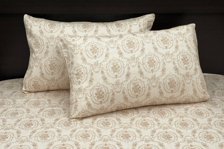 A custom bed sheet set with floral print in shades of beige displayed on a bed 1.