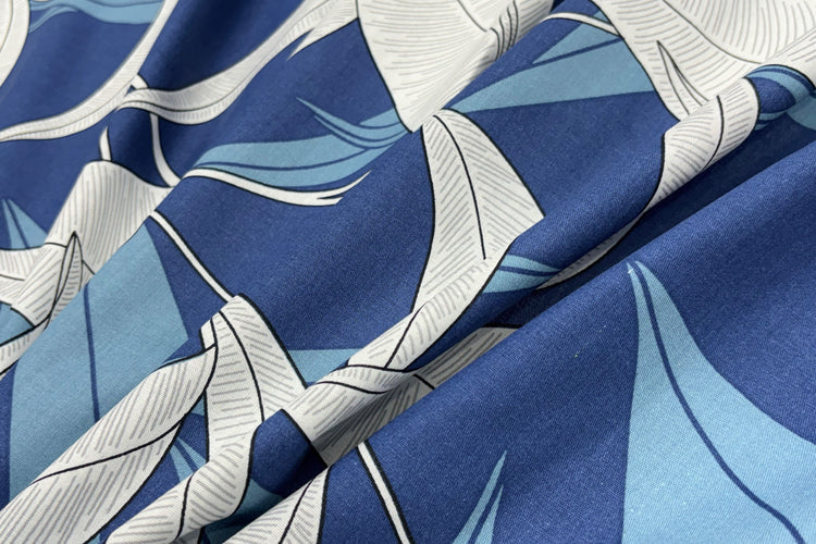 A custom bed sheet with a floral print in blue tones