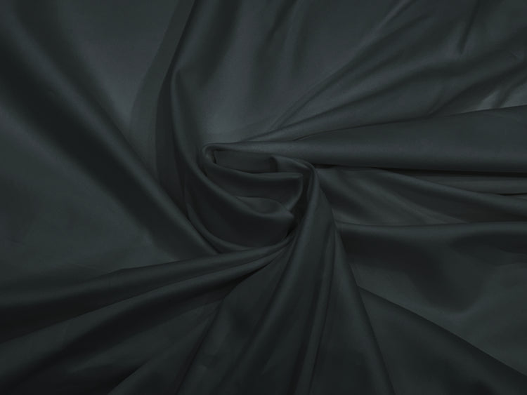 A dark grey, sateen weave bed sheet set displayed in a twisted .