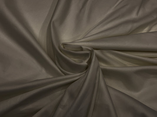 A khaki-colored, soft sateen weave bed sheet .