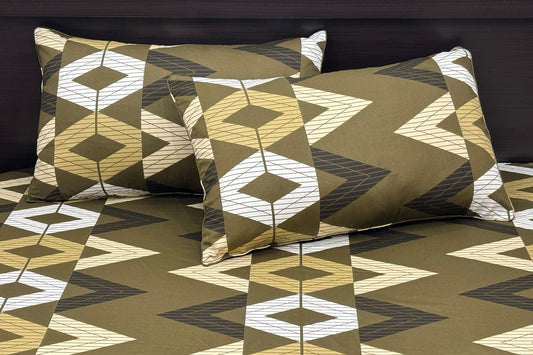 A set of green bed sheets and pillows with a geometric pattern.