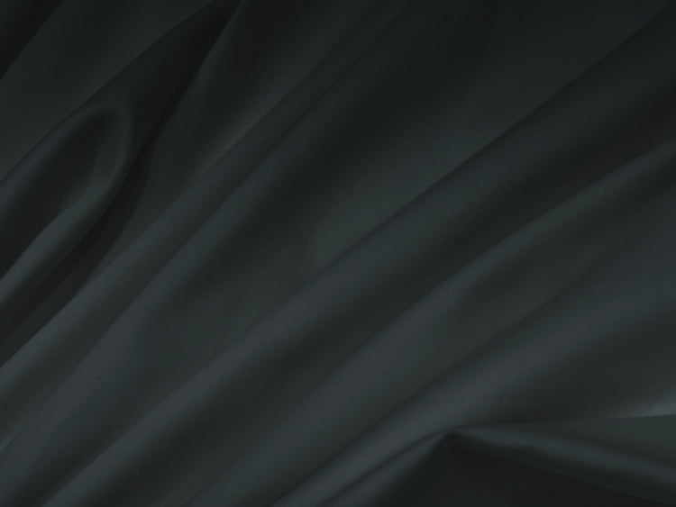 Bedsheet Smooth, flowing black silk fabric with soft folds .