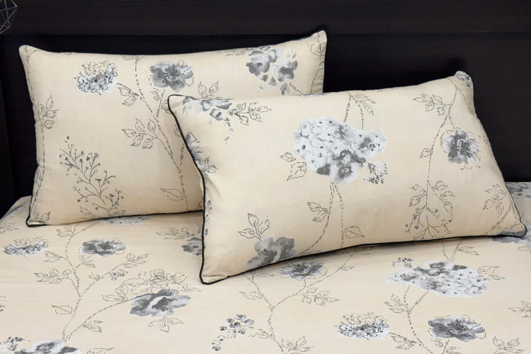Beige bedspread with a delicate gray floral pattern, featuring matching pillows 2.