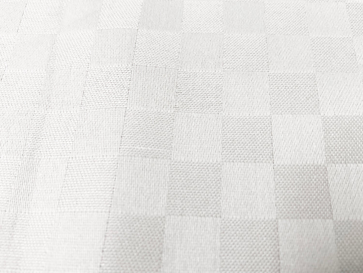 Close-up view of a white custom bed sheet with a sateen self square weave pattern 3.