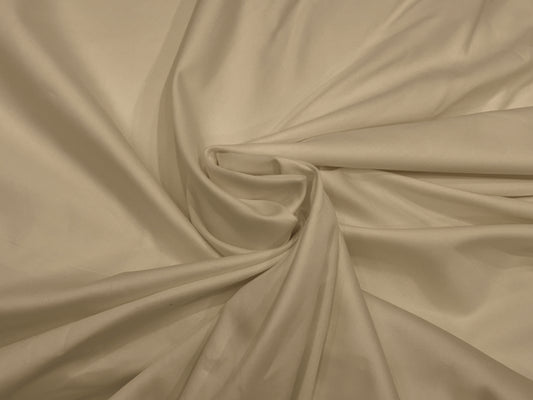Cream-colored fabric bedsheet swirled in a circular pattern.