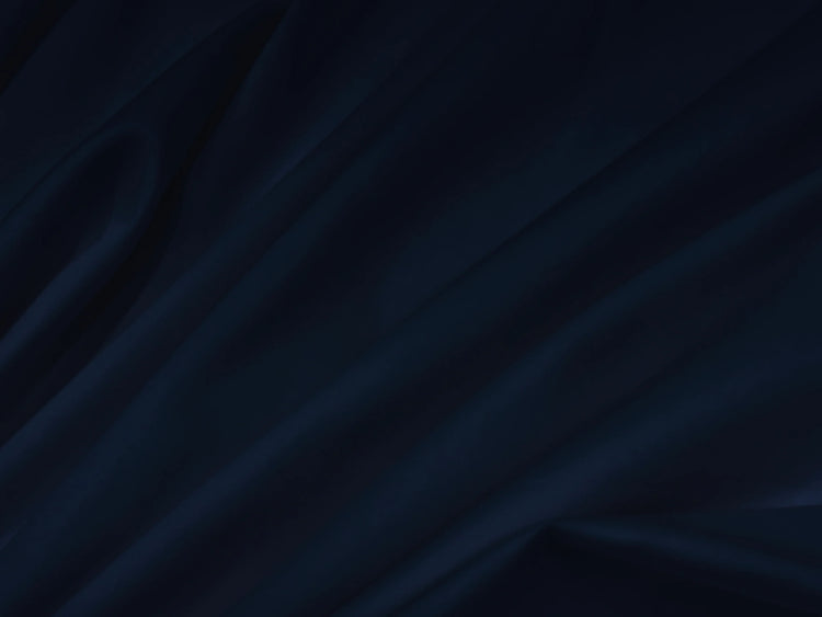 Dark blue fabric with soft, flowing folds bedsheet.