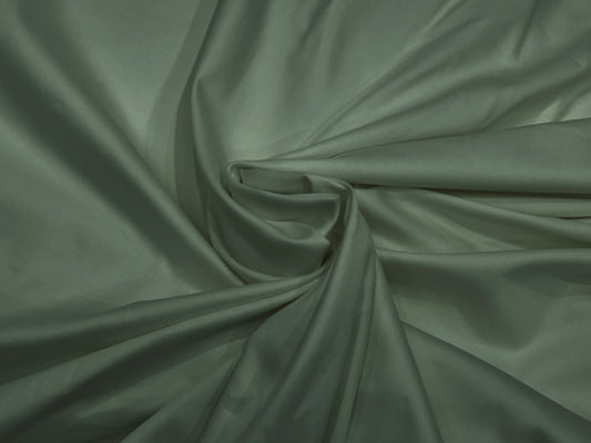 Elegant drape of soft, sage green fabric with a subtle sheen.