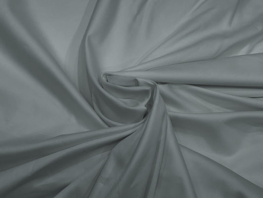 Smooth gray satin fabric bedsheet neatly arranged in a gentle swirl at the center, creating elegant folds .