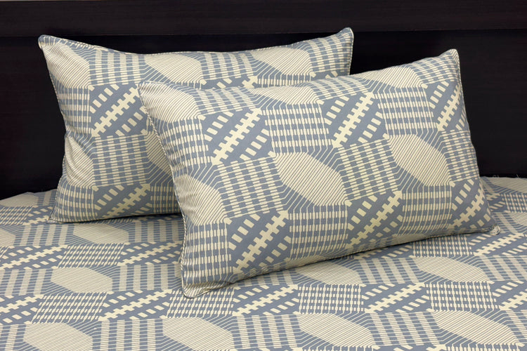 bedsheet and matching pillows featuring geometric blue and beige designs 1.