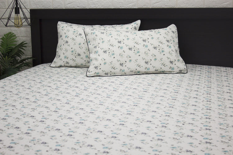 bedsheet and two pillows with a floral print design, shades of blue and green 1 .