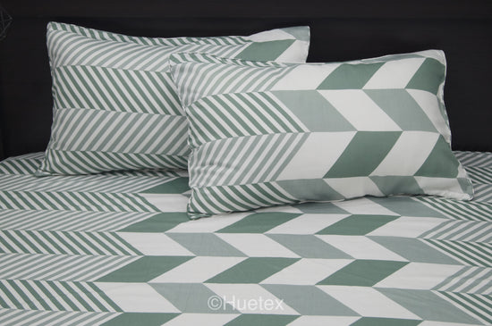 A bed with a geometric patterned aqua bed sheet set 1.