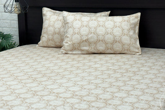 A beige custom bed sheet set with floral print and piping pattern displayed on a bed, including two pillows.