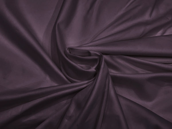 A close-up image of a purple, soft sateen weave bed sheet fabric.