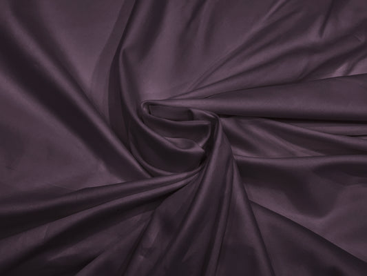 A close-up image of a purple, soft sateen weave bed sheet fabric.