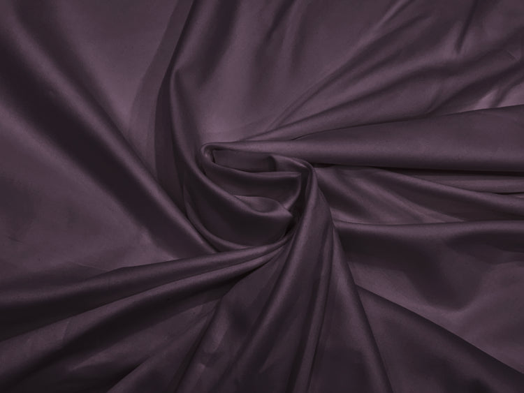 A close-up image of a purple, soft sateen weave bed sheet fabric.