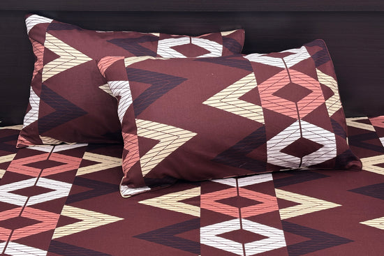 A custom bed sheet set in brown with geometric print, including a bedsheet and two pillowcases