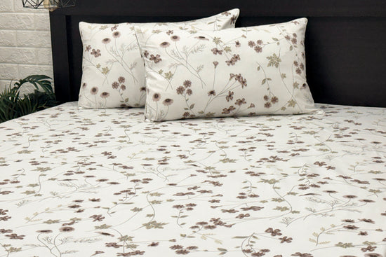 A custom bed sheet set, two cotton pillows with white and  featuring a floral print .