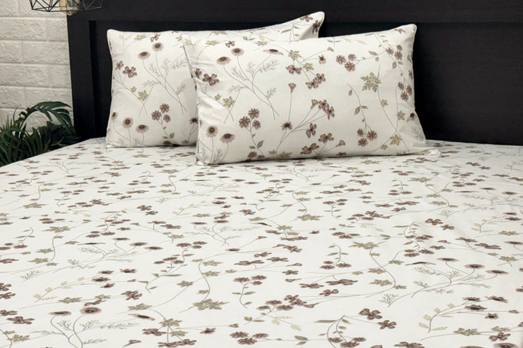 A custom bed sheet set, two cotton pillows with white and  featuring a floral print .