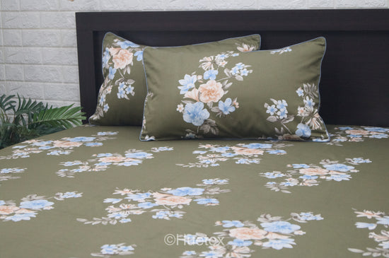 A custom bed sheet set with a floral geometric print in green.