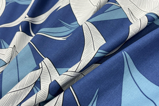 A custom bed sheet with a floral print in blue tones