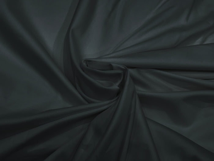 A dark grey, sateen weave bed sheet set displayed in a twisted .