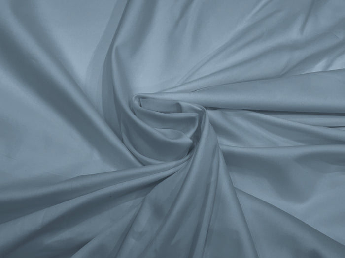 A draped bed sheet with a soft blue color and a sateen weave texture.