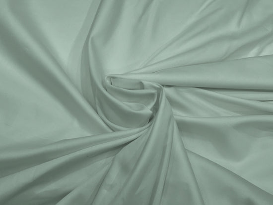A draped bed sheet with a soft green color, showcasing the sateen weave texture.
