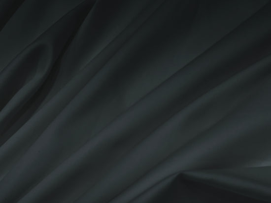 Bedsheet Smooth, flowing black silk fabric with soft folds .