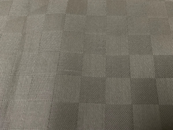 Close-up view of a beige checkered pattern bed sheet fabric 3.