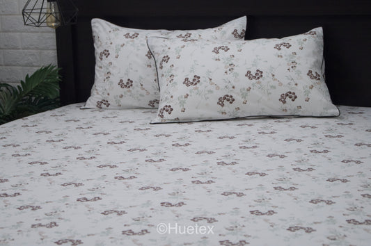 Custom bed sheet set with floral print with brown, white, and green colors.