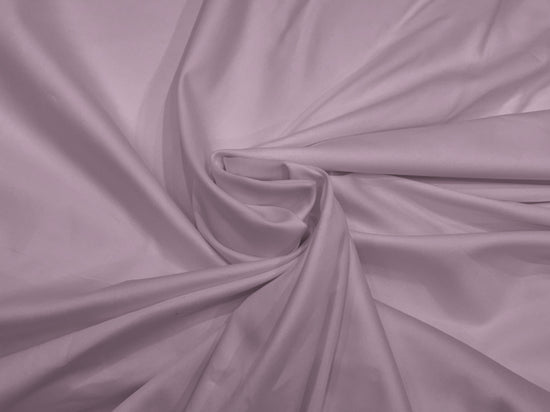 Lilac fabric with soft folds creates a swirling pattern. 