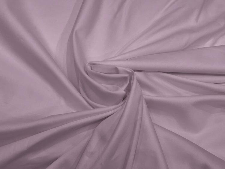 Lilac fabric with soft folds creates a swirling pattern. 
