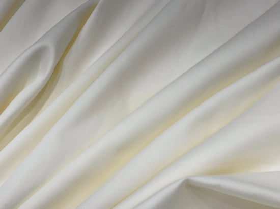 Smooth, flowing ivory satin fabric with gentle folds.