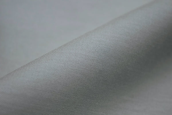Smooth gray fabric with a soft texture, angled and slightly folded.