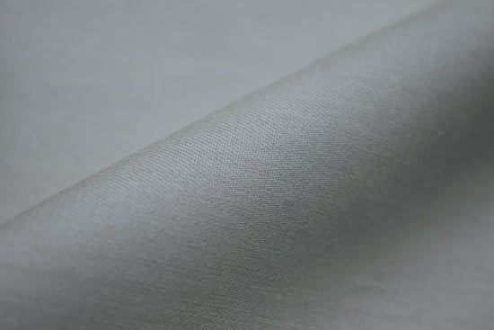 Smooth gray fabric with a soft texture, angled and slightly folded.