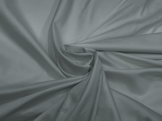 Smooth gray satin fabric bedsheet neatly arranged in a gentle swirl at the center, creating elegant folds .