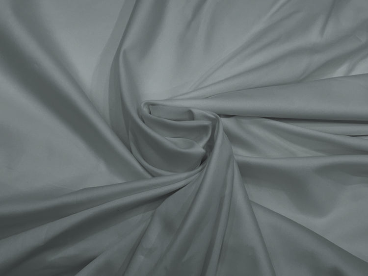Smooth gray satin fabric bedsheet neatly arranged in a gentle swirl at the center, creating elegant folds .