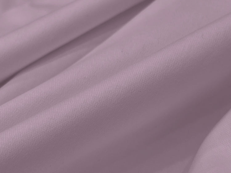 Smooth lavender fabric folds create an elegant, soft texture, suggesting comfort and luxury