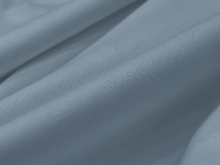 Smooth, light grey fabric with soft folds and gentle shadows.