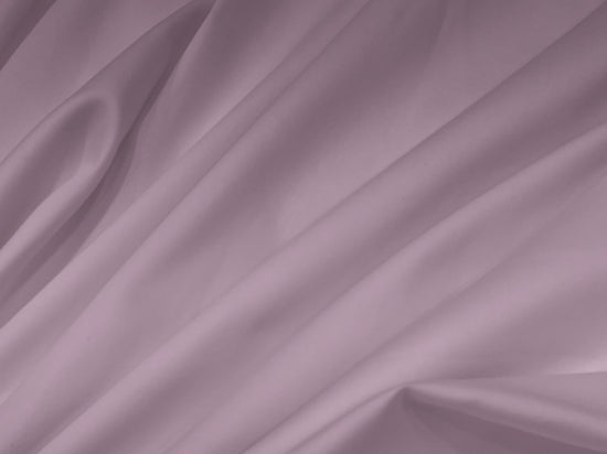 Soft light purple fabric with gentle folds and smooth texture.