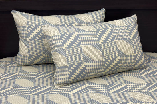 bedsheet and matching pillows featuring geometric blue and beige designs 1. 