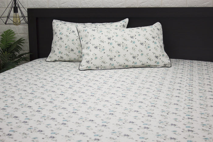bedsheet and two pillows with a floral print design, shades of blue and green 1 .