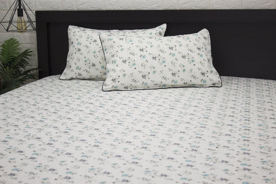 bedsheet and two pillows with a floral print design, shades of blue and green 1 .
