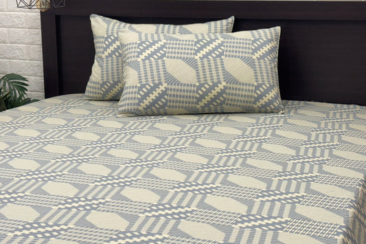 bedsheetand matching pillows featuring geometric blue and beige designs. 