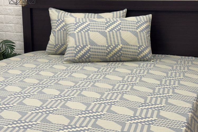 bedsheetand matching pillows featuring geometric blue and beige designs. 